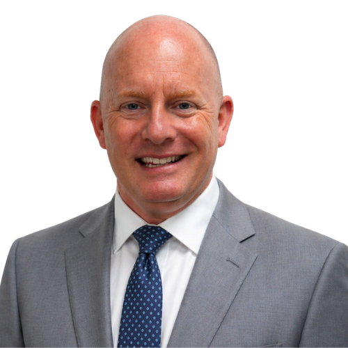 Smiling bald man in a gray suit and blue tie against a white background.